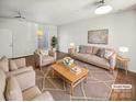 Bright, staged living room with modern furniture, hardwood floors, and neutral color palette at 6466 Mallard View Ln, Charlotte, NC 28269
