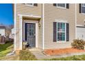 Welcoming front entrance with a black door, decorative plants, and a cozy porch area at 6523 Matlea Ct, Charlotte, NC 28215