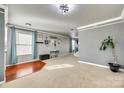 Bright living room with hardwood floors, large windows with blue curtains, and elegant decor at 6523 Matlea Ct, Charlotte, NC 28215
