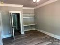 Cozy bedroom with built-in shelves, neutral paint, hardwood floors and ceiling fan at 7221 Static Way # 13, Sherrills Ford, NC 28673