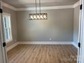 Clean dining room with hardwood floors, neutral paint, with a modern light fixture at 7221 Static Way # 13, Sherrills Ford, NC 28673