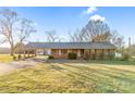 Traditional-style brick home with a covered parking area and well-maintained lawn, radiating warmth at 7270 Long Island Rd, Catawba, NC 28609