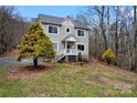 Charming two-story home with gray roof and a landscaped yard, and a cozy front porch at 946 Laurelwood Dr, Clover, SC 29710