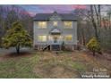 Two-story home with inviting porch and large windows, set against a twilight sky at 946 Laurelwood Dr, Clover, SC 29710