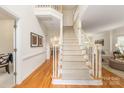 Bright foyer with hardwood floors and a staircase, creating an elegant and welcoming entrance at 1006 Baldwin Ln, Waxhaw, NC 28173