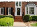 Inviting front entrance with brick steps and elegant details, showcasing the home's curb appeal at 1006 Baldwin Ln, Waxhaw, NC 28173