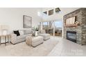 Inviting living room with stone fireplace and sliding glass doors to the outdoor balcony at 1008 Southwest Dr # 8, Davidson, NC 28036