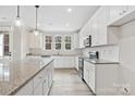 Modern kitchen featuring white cabinets, granite countertops, stainless steel appliances, and an oversized kitchen island at 108 Glencoe Ln # 105, Mooresville, NC 28117