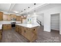 Spacious kitchen with island, stainless steel appliances, and decorative pendant lighting at 109 Stonewater Dr # 26, Red Cross, NC 28129