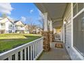 Relaxing front porch view with white railings, stone pillars, and a view of the lawn at 11013 Dundarrach Ln, Charlotte, NC 28277