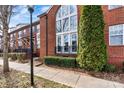 Beautiful brick townhouse with a large arched window and manicured landscaping, offering classic curb appeal at 121 Irving Ave # F, Mooresville, NC 28117
