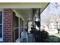 Cozy covered porch featuring classic brick columns and wrought iron details; perfect spot for relaxing at 121 Quincy Dr # 1, Belmont, NC 28012