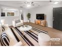 Cozy living room with modern decor, a ceiling fan, and hardwood floors at 13413 Glasgow Green Ln, Charlotte, NC 28213