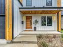 Close up of the modern front porch with its sleek door and bright modern accents at 1516 N Caldwell St, Charlotte, NC 28206