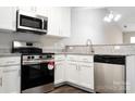 Modern kitchen features stainless steel appliances, granite countertops, and white cabinetry at 1517 Tiana Way, Rock Hill, SC 29732