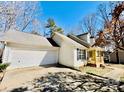 Lovely home with attached garage, covered front porch, and well-maintained driveway at 177 Highland Woods Ct, Denver, NC 28037