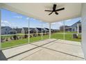 Spacious covered patio with concrete flooring, ceiling fan, and backyard view at 2014 Mantle Ridge Dr, Indian Trail, NC 28079