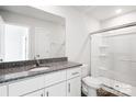 Clean and bright bathroom with white cabinets, granite countertop, and glass-enclosed shower at 225 Kennerly Ave # A, Mooresville, NC 28115