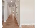 View of a long hallway with hardwood floors and white walls, leading to another room at 237 Miramar Dr, York, SC 29745