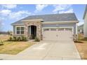 Charming home with stone accents, attached two-car garage, and well-maintained front yard at 2405 Lorelei Ter, Monroe, NC 28112