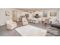 Open-concept living area features a bright kitchen with island seating and dining at 2405 Lorelei Ter, Monroe, NC 28112