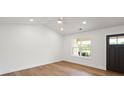Bright bedroom featuring hardwood floors, recessed lighting, and a large window offering plenty of natural light at 2425 Ellen Ave, Charlotte, NC 28208