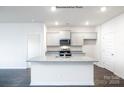Bright kitchen featuring a center island with granite countertops, stainless steel appliances and ample cabinet space at 3009 Sassafras Trl, Gastonia, NC 28056