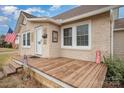 Close-up of front porch with wood flooring, a welcome mat, and charming decorative touches on the exterior at 306 W 2Nd St, Cherryville, NC 28021