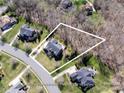 Aerial view showing home and property lines surrounded by trees at 409 Running Horse Ln, Waxhaw, NC 28173