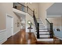 Grand foyer with hardwood floors, staircase, and views into other living spaces at 409 Running Horse Ln, Waxhaw, NC 28173
