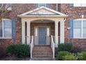 Inviting front porch with brick steps and decorative pillars at 409 Running Horse Ln, Waxhaw, NC 28173