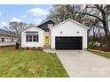 Charming new construction home featuring a black garage door and a bright yellow front door at 412 W Westview St, Gastonia, NC 28052