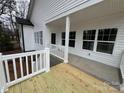 Covered back porch with white railing overlooking the backyard at 412 W Westview St, Gastonia, NC 28052