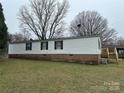 The home features a classic design with a brick foundation and a well-manicured lawn at 459 Towell St, Mooresville, NC 28115