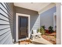 Inviting front entryway with a dark door, a charming bench, and a 'Hello Gorgeous' welcome mat at 502 Tayberry Ln, Fort Mill, SC 29715