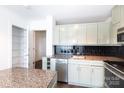 Well-lit kitchen with stainless steel appliances and sage cabinets and a black subway tile backsplash at 505 E 6Th St # 1006, Charlotte, NC 28202