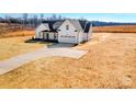 Exterior view showcasing the home's white facade, roofline, and a spacious front yard at 520 Shoal Rd, Lincolnton, NC 28092