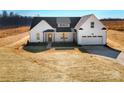 New construction home features a modern farmhouse design and attached two car garage at 520 Shoal Rd, Lincolnton, NC 28092