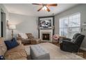 Cozy living room featuring a fireplace, ceiling fan and comfortable seating at 7834 Jester Park Dr, Huntersville, NC 28078