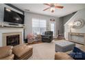 Inviting living room showcasing a fireplace, hardwood floors and natural light at 7834 Jester Park Dr, Huntersville, NC 28078