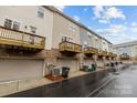 Townhome complex featuring rear garages and private wooden balconies at 824 Imperial Ct, Charlotte, NC 28273