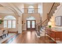 Elegant foyer with hardwood floors, staircase, and arched entryway at 9901 Strike The Gold Ln, Waxhaw, NC 28173
