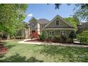 Beautifully landscaped front yard with mature trees and lush green lawn at 9901 Strike The Gold Ln, Waxhaw, NC 28173