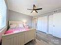Comfortable bedroom featuring light gray walls, wood-look flooring, and double closets at 1056 Latham Ct # B104, Rock Hill, SC 29732