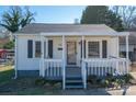 Charming single-story home with a covered front porch, gray shutters, and landscaped yard at 116 Garrison Dr, Belmont, NC 28012