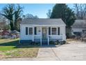 Charming single-story home with a covered front porch, gray shutters, and landscaped yard at 116 Garrison Dr, Belmont, NC 28012