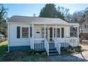 Charming single-story home with a covered front porch, gray shutters, and landscaped yard at 116 Garrison Dr, Belmont, NC 28012