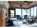 The screened porch has wood ceiling, ceiling fans, ample seating, and views of the outdoors at 152 Muskhogean Way, Mount Gilead, NC 27306