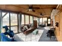 The screened porch has a wood ceiling, ceiling fans, seating and overlooks a lake view at 152 Muskhogean Way, Mount Gilead, NC 27306