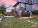Modern two-story home featuring a garage, backyard patio, and string lights at 1921 Union St, Charlotte, NC 28205